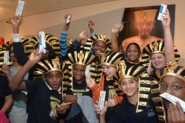 Students from the Downtown Academy of Technology and Arts wave their free tickets for the exhibition "Tutankhamun and the Golden Age of the Pharaohs" Tuesday Oct. 18, 2005 at the Museum of Art/Fort Lauderdale in Fort Lauderdale, Fla.   Northern Trust, one of the world's largest private banking firms, is the exhibition's US sponsor and donated the tickets to the children.  Ticket sales begin today.   The touring exhibition, organized by National Geographic, AEG Exhibitions and Arts and Exhibitions International, with cooperation from the Egyptian Supreme Council of Antiquities, will open at the museum of Art/Fort Lauderdale on Dec. 15, 2005.  The exhibit kicked off it's US tour in Los Angeles on June 16, 2005, marking the first time the treasures of King Tut  visited America in 26 years.   (AP PHOTO/MoA/FL, David Adame)
